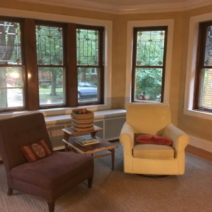 Living room in West Ridge, multiple restored double hung windows.